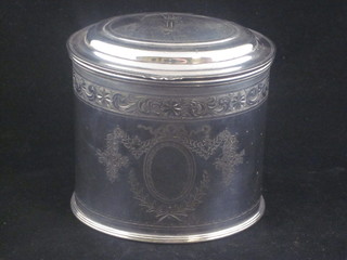A Georgian style oval engraved silver caddy with hinged lid with armorial decoration