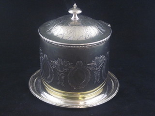 A cylindrical engraved silver plated biscuit barrel with hinged lid