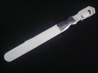 An ivory and silver newspaper opener with silver band, the  handle in the form of a claw with pearl, handle cracked, London  1911