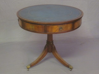 A circular Georgian style mahogany drum table with blue inset writing surface, raised on a pillar and tripod base 32"   ILLUSTRATED