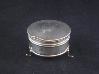 A cylindrical silver trinket box with hinged lid and engine turned decoration, raised on hoof feet, Birmingham 1919, dent to lid