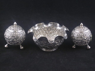 An Eastern circular embossed white metal bowl together with 2 matching pepperettes