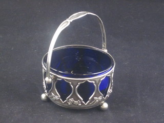 A circular Edwardian pierced silver sugar bowl with blue glass liner, Birmingham 1906