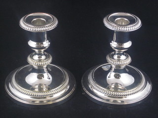 A pair of circular silver plated candlesticks with rope edge  borders 6"