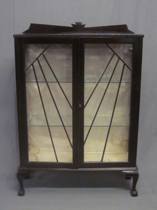 An Art Deco mahogany display cabinet, the interior fitted glazed shelves enclosed by astragal glazed panelled doors, raised on  cabriole supports 36"
