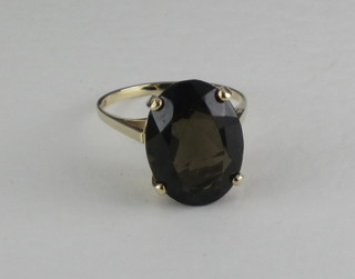 A gold ring set an oval cut smoky quartz