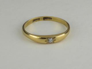 An 18ct gold ring set a diamond