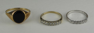 A gold signet ring set a hardstone and 2 other rings