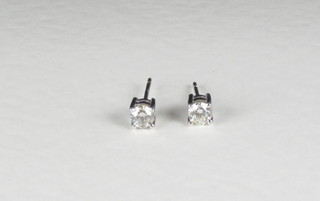 A pair of diamond stud earrings, approx 0.67ct