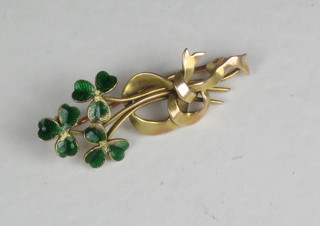 A 15ct gold brooch with enamelled sprigs of clover