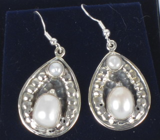 A pair of silver and freshwater pearl drop earrings