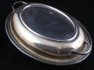 An oval silver plated twin handled entree dish and cover