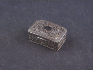 A carved Eastern horn snuff box with hinged lid decorated  figures 2 1/2"