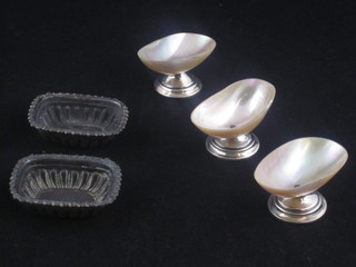 A pair of Victorian embossed silver salts together with 3 mother of pearl and silver mounted salts
