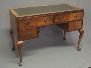An Art Deco walnut writing table with inset green writing surface above 2 long and 2 short drawers, raised on cabriole supports 45"