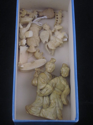 A carved ivory figure of a standing lady and gentleman together  with a collection of other carved ivory figures etc