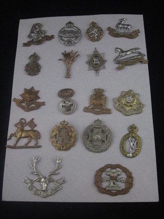 A collection of 18 various military cap badges including Royal Welsh Fusiliers, Gordon Highlanders, Queens, Royal Tank  Regt., Queens Royal Army Corps