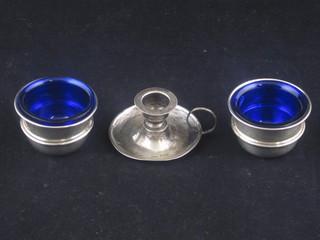 An Edwardian miniature silver chamberstick together with 2 circular silver salts with blue glass liners