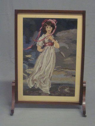 A mahogany firescreen with Berlin woolwork panel decorated a bonnetted lady 21", reduced in height,