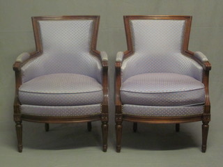 A pair of mahogany show frame tub back chairs upholstered in  blue material