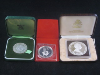 An Elizabeth II 1972 Silver Wedding silver proof crown, a  Bahamas 10 dollar silver proof crown and an Anguilla silver  proof Independence crown