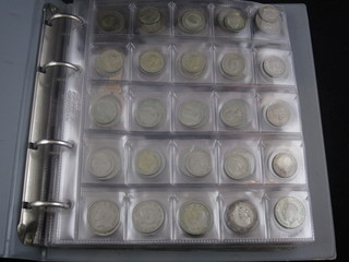 A loose leaf album containing various coins