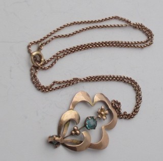 An Edwardian 9ct gold pendant set a blue stone hung on a gold  chain