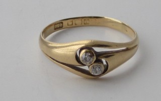 An 18ct gold dress ring set 2 diamonds