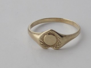 A gold heart shaped signet ring