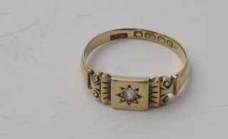 An 18ct yellow gold dress ring set a small diamond