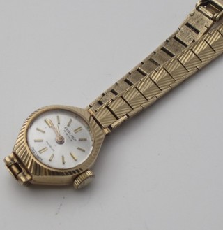 A lady's Excalibur wristwatch contained in a 9ct gold case with integral bracelet