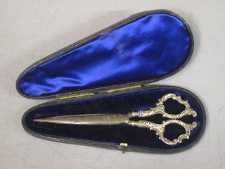 A pair of Victorian silver handled scissors with polished steel blades, cased
