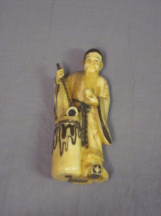 A carved ivory figure of a standing gentleman, the base with red  seal mark 5"