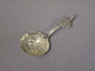 A Dutch embossed silver spoon decorated a bridge and windmill