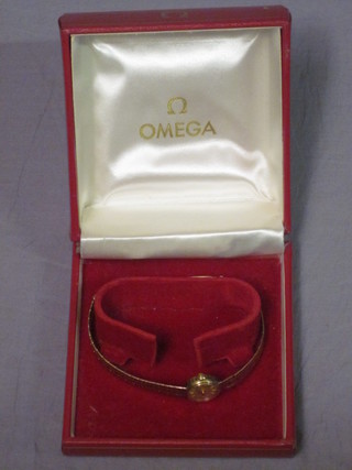 A lady's Omega wristwatch contained in a 9ct gold case with integral bracelet, boxed