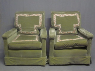 A pair of mahogany framed armchairs upholstered in green material