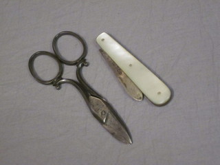 A silver bladed fruit knife with mother of pearl grip and a pair of Victorian polished steel scissors