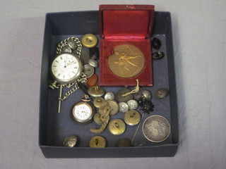 An open faced pocket watch contained in a chrome case, a curb link watch chain, a fob watch in a gun metal case, a medallion  and various buttons etc