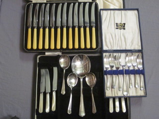 A 13 piece silver plated fruit service comprising serving spoon, 6  knives and spoons, a set of 12 tea knives and a set of 6 silver  plated cake knives and forks, all cased