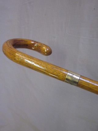 A walking stick with gilt metal band