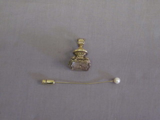 A gilt metal seal together with a stick pin