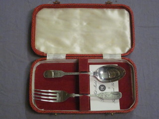 A silver christening set comprising fiddle pattern spoon and fork, cased