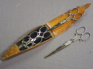 A set of 6 Victorian polished steel scissors by Savigny & Co, contained in a leather case