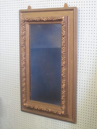 A rectangular plate mirror contained in a decorative gilt frame 33"