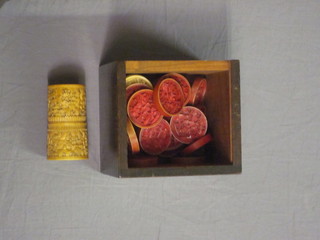 A red and white carved ivory drafts set decorated Oriental scenes  together with a die shaker, base missing