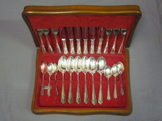 A modern canteen of silver plated flatware, contained in a teak canteen box