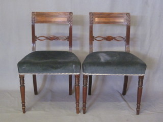 A pair of Georgian mahogany bar back dining chairs with pierced  mid rails and upholstered seats, raised on turned supports