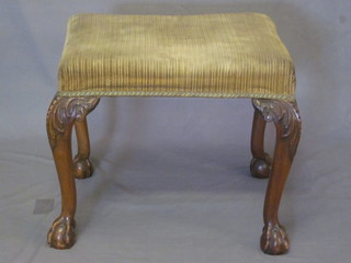 A rectangular Queen Anne style walnut stool, raised on carved cabriole ball and claw supports 21"