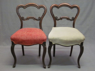 A pair of Victorian mahogany balloon back dining chairs with shaped mid rails