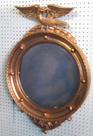 A Regency style convex plate wall mirror contained in a gilt ball studded frame surmounted by an eagle 18"